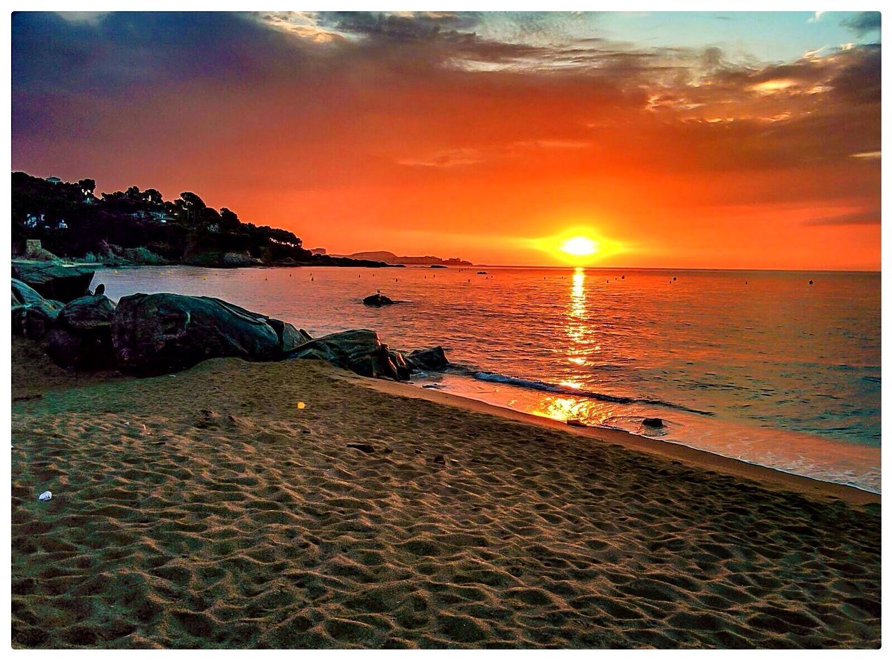 SCENIC VIEW OF SUNSET OVER SEA