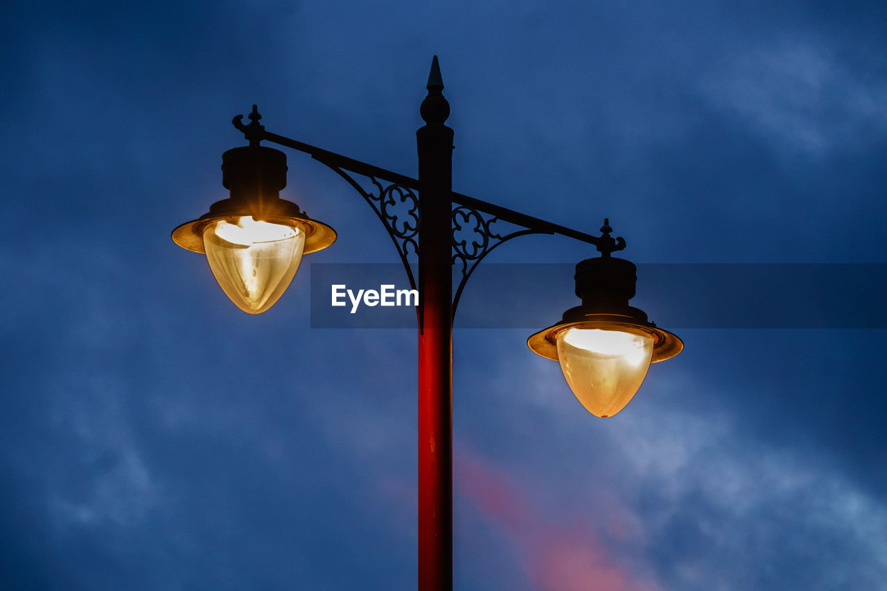 Low angle view of lamp post against sky