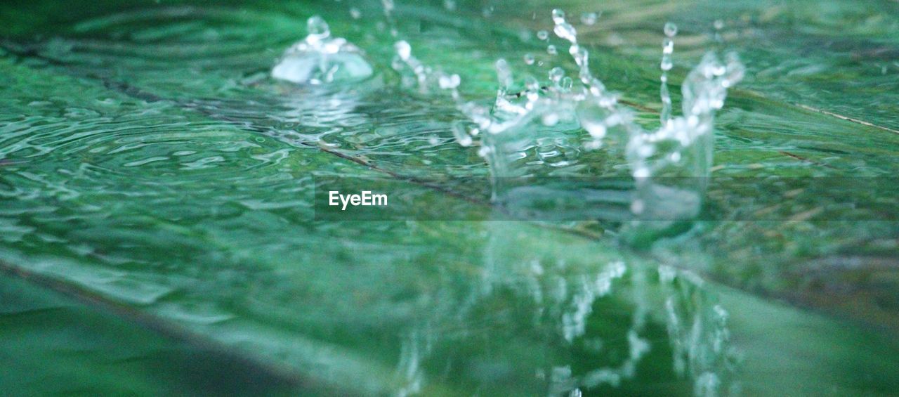 CLOSE-UP OF WATER FLOWING IN SUNLIGHT