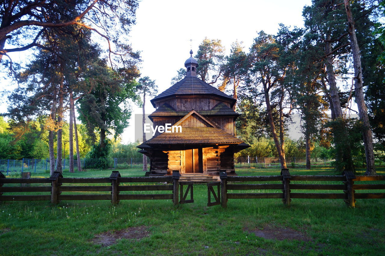 GAZEBO ON FIELD AGAINST TREES