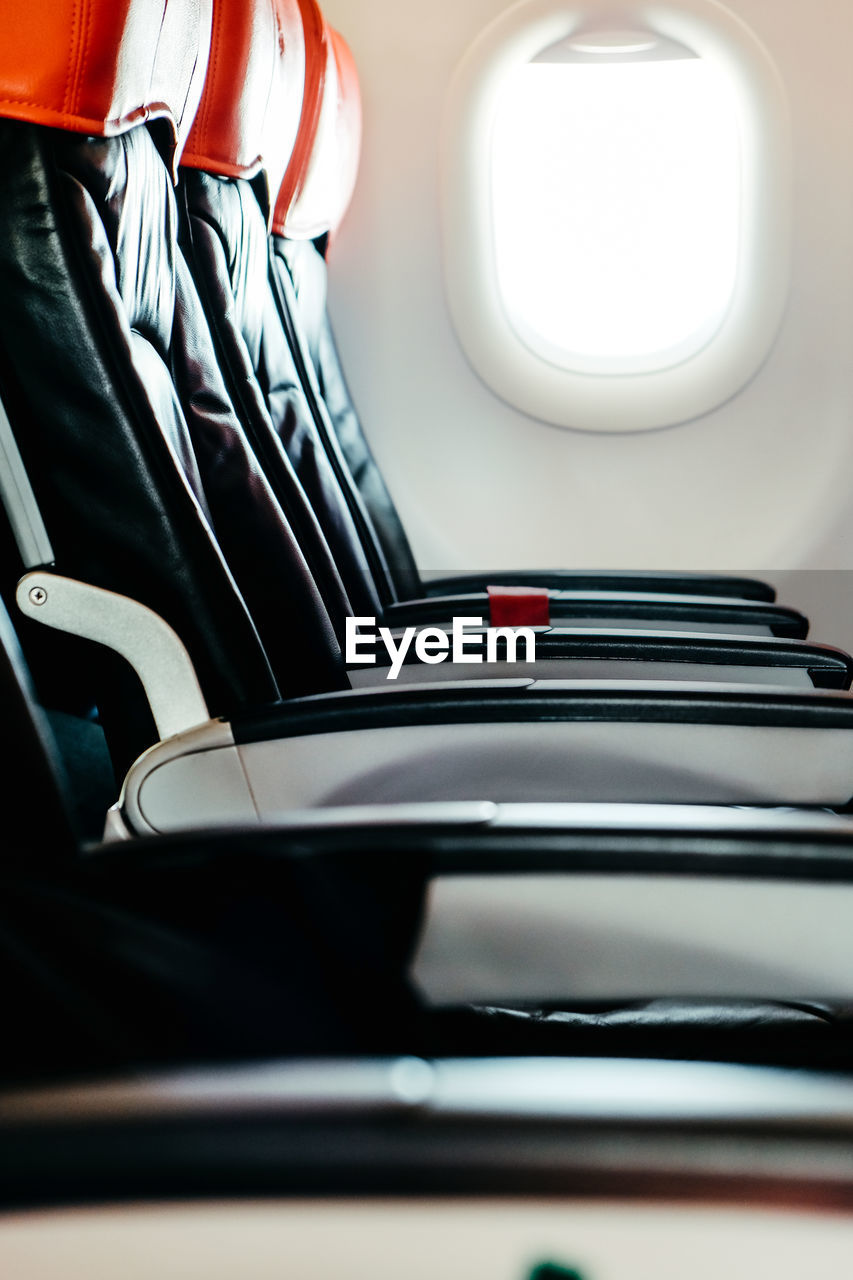 Image of empty airplane seats and window. airplane interior background