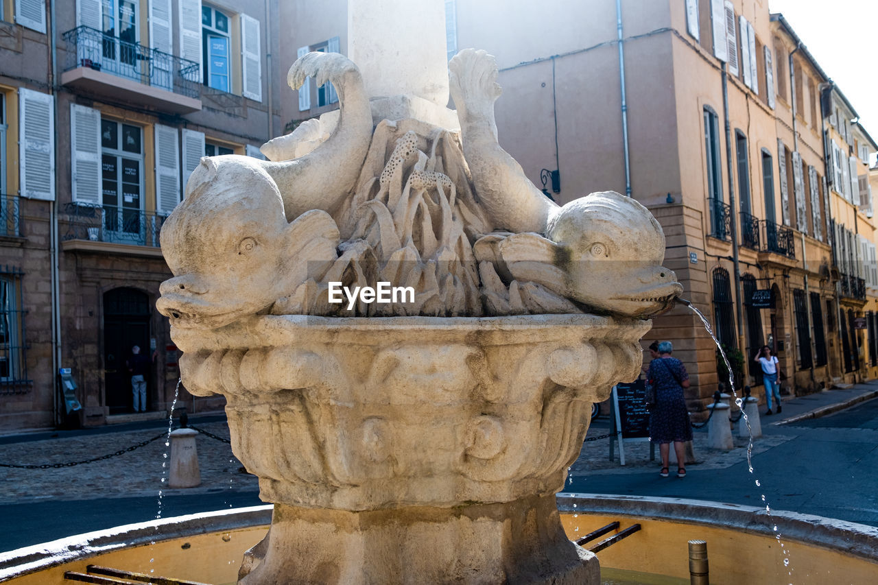 STATUE IN FOUNTAIN IN CITY