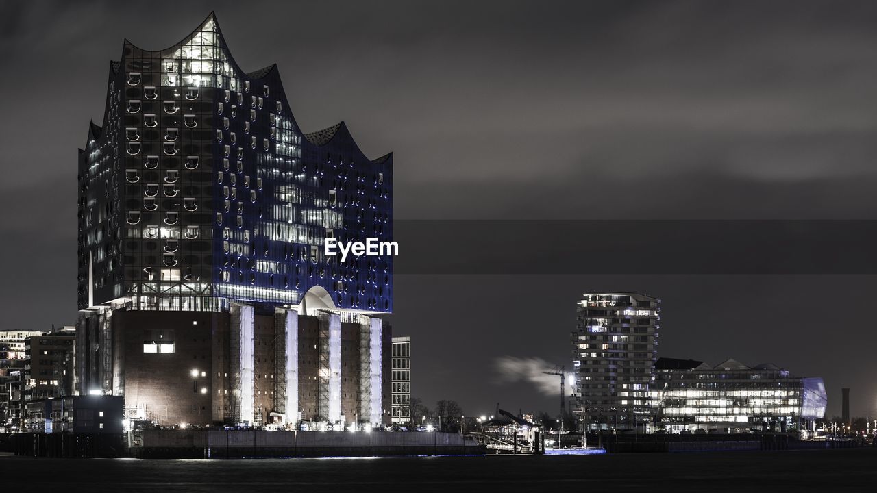 Illuminated modern building against sky