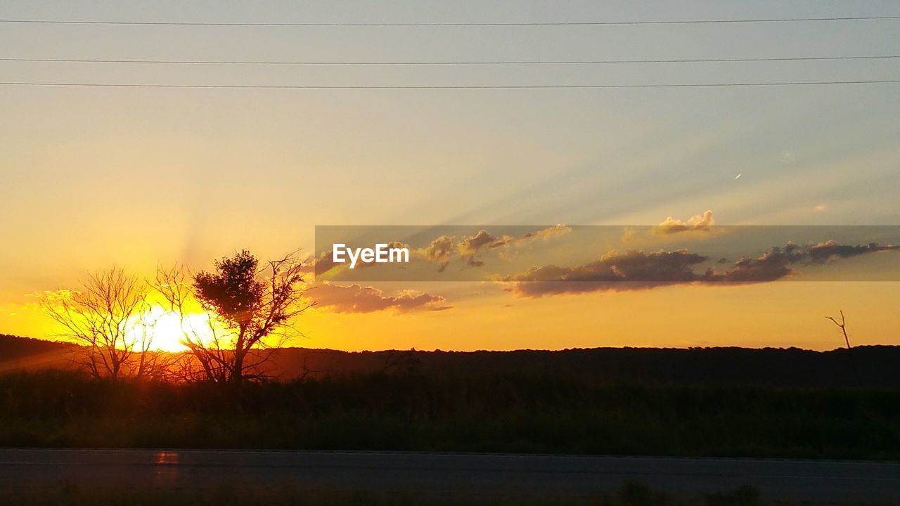 Scenic view of silhouette landscape against sky at sunset