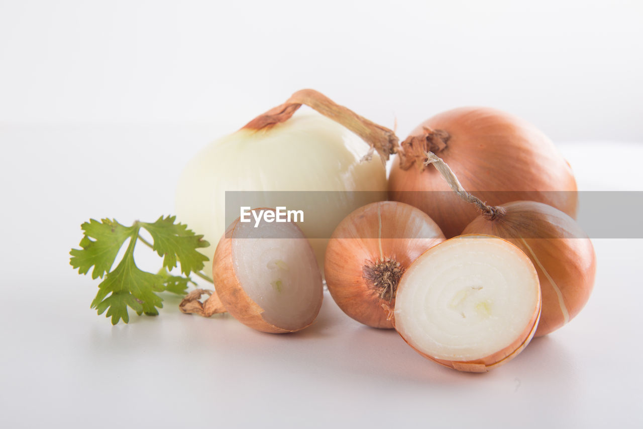 CLOSE-UP OF GARLIC ON WHITE BACKGROUND