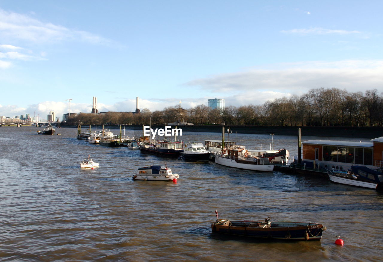 Boats moored in the middle of the thames, london, united kingdom.