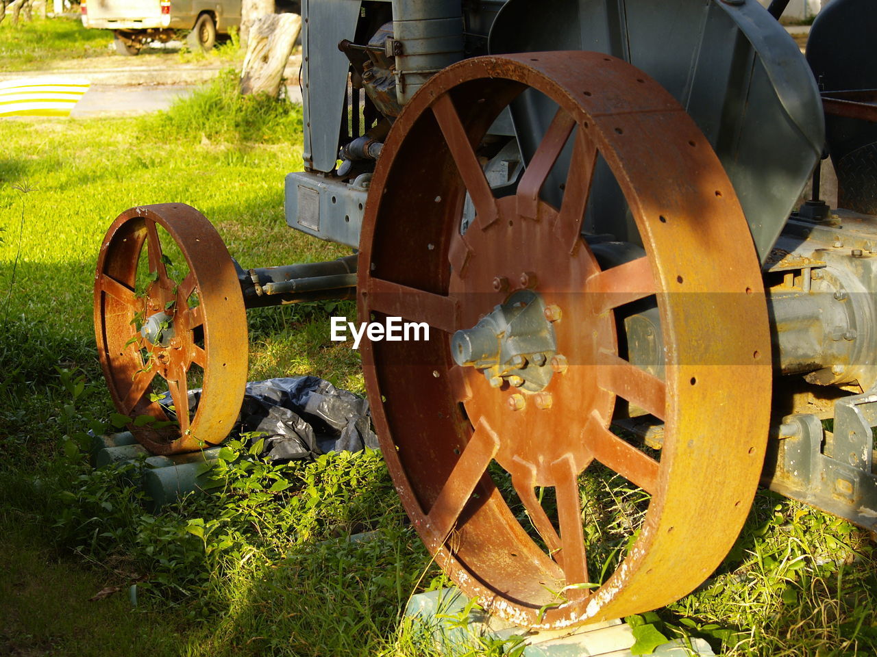 CLOSE-UP OF MACHINERY ON FIELD BY TRAIN