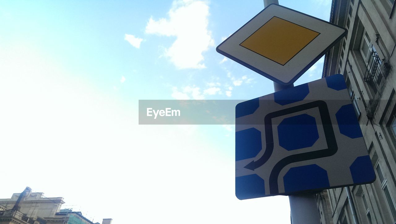 LOW ANGLE VIEW OF BUILT STRUCTURES AGAINST BLUE SKY