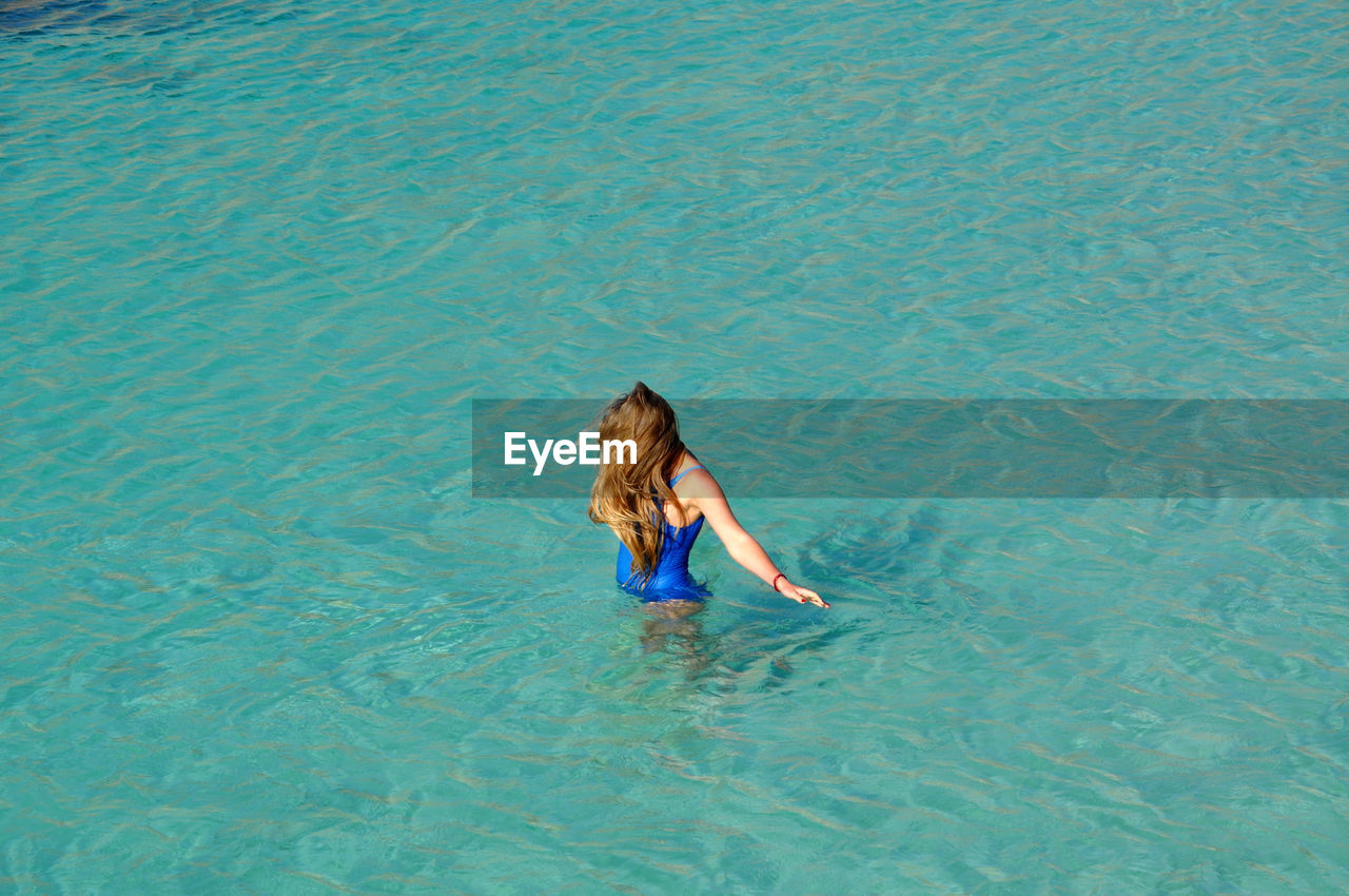 High angle view of girl swimming in sea
