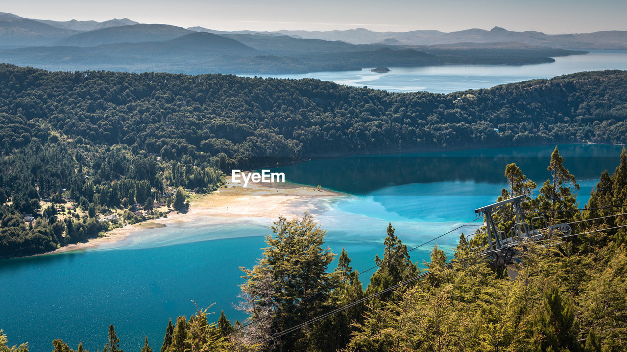 High angle view of sea and mountains against sky