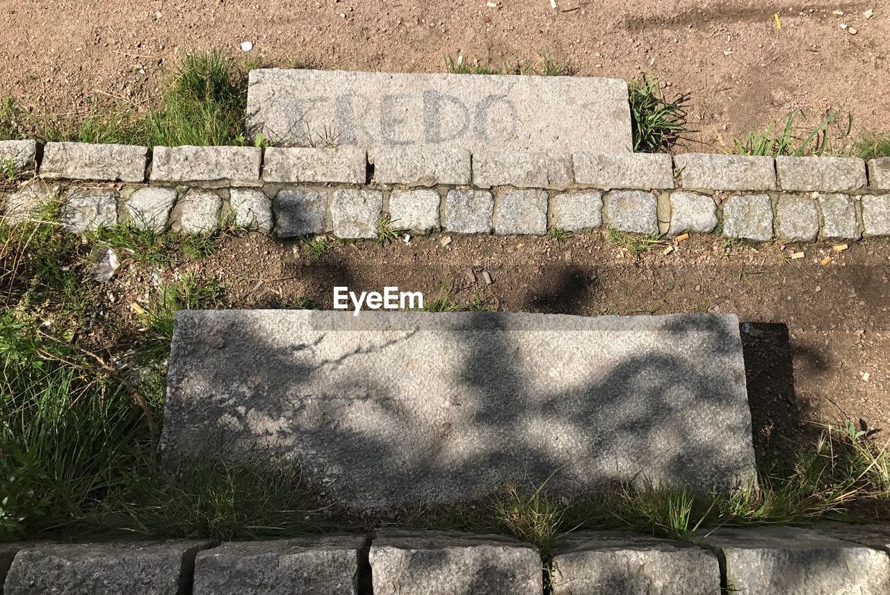 SHADOW OF STONE WALL ON RETAINING