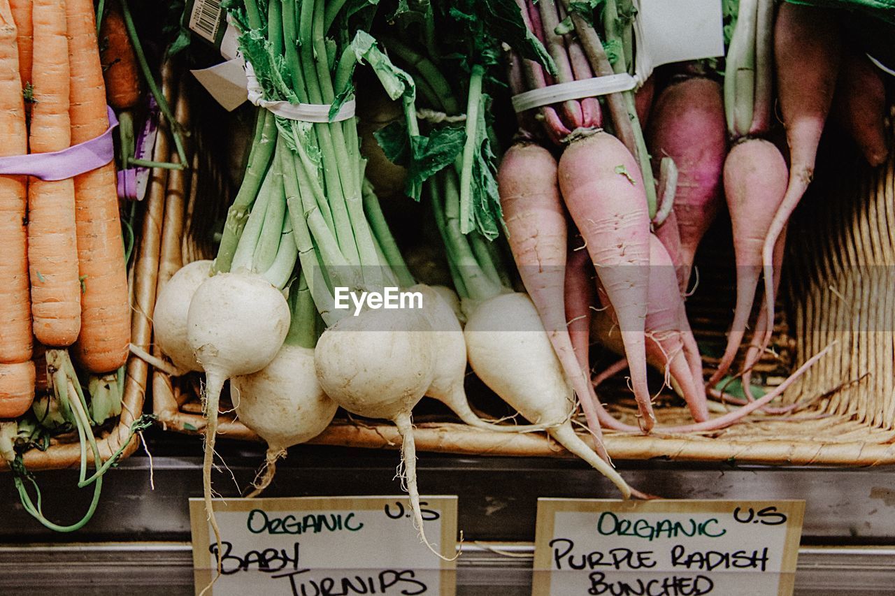 Close-up of vegetables with labels for sale in market