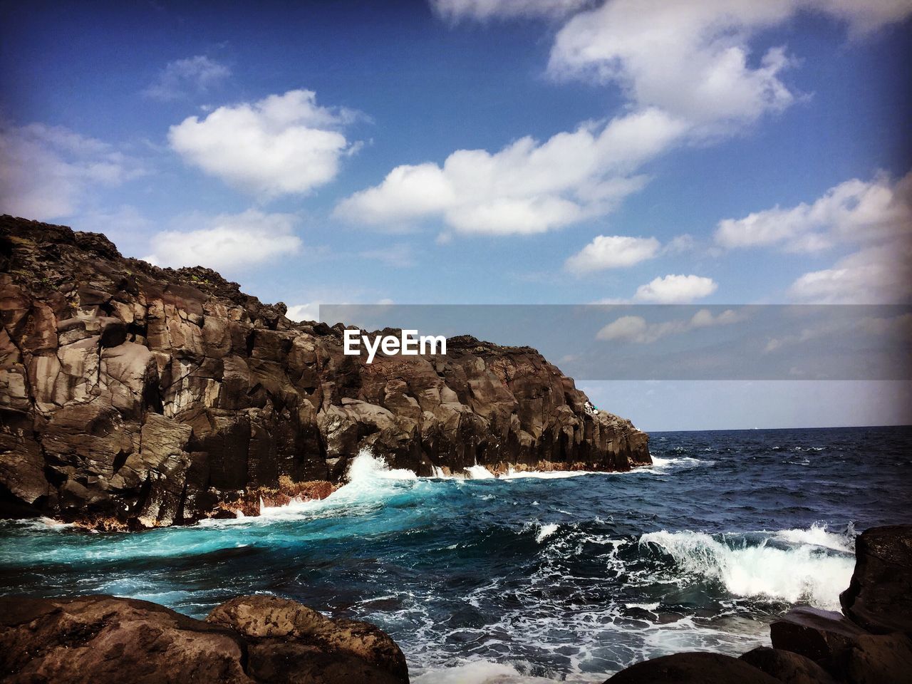 Scenic view of sea against cloudy sky