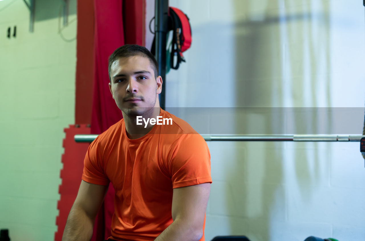 sports, exercising, lifestyles, sports training, athlete, adult, gym, young adult, one person, sports clothing, strength, health club, men, muscular build, indoors, physical fitness, player, clothing, looking at camera, portrait, room, determination, relaxation, front view, sport venue, leisure activity, wellbeing, vitality, person, waist up