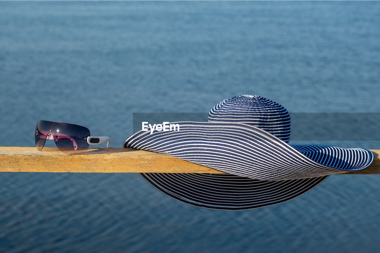 blue, water, wing, no people, sea, focus on foreground, day, vehicle, surfing equipment, close-up, nature, outdoors