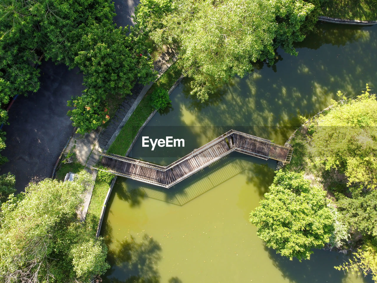 Aerial view wooden bridge near green tree natural