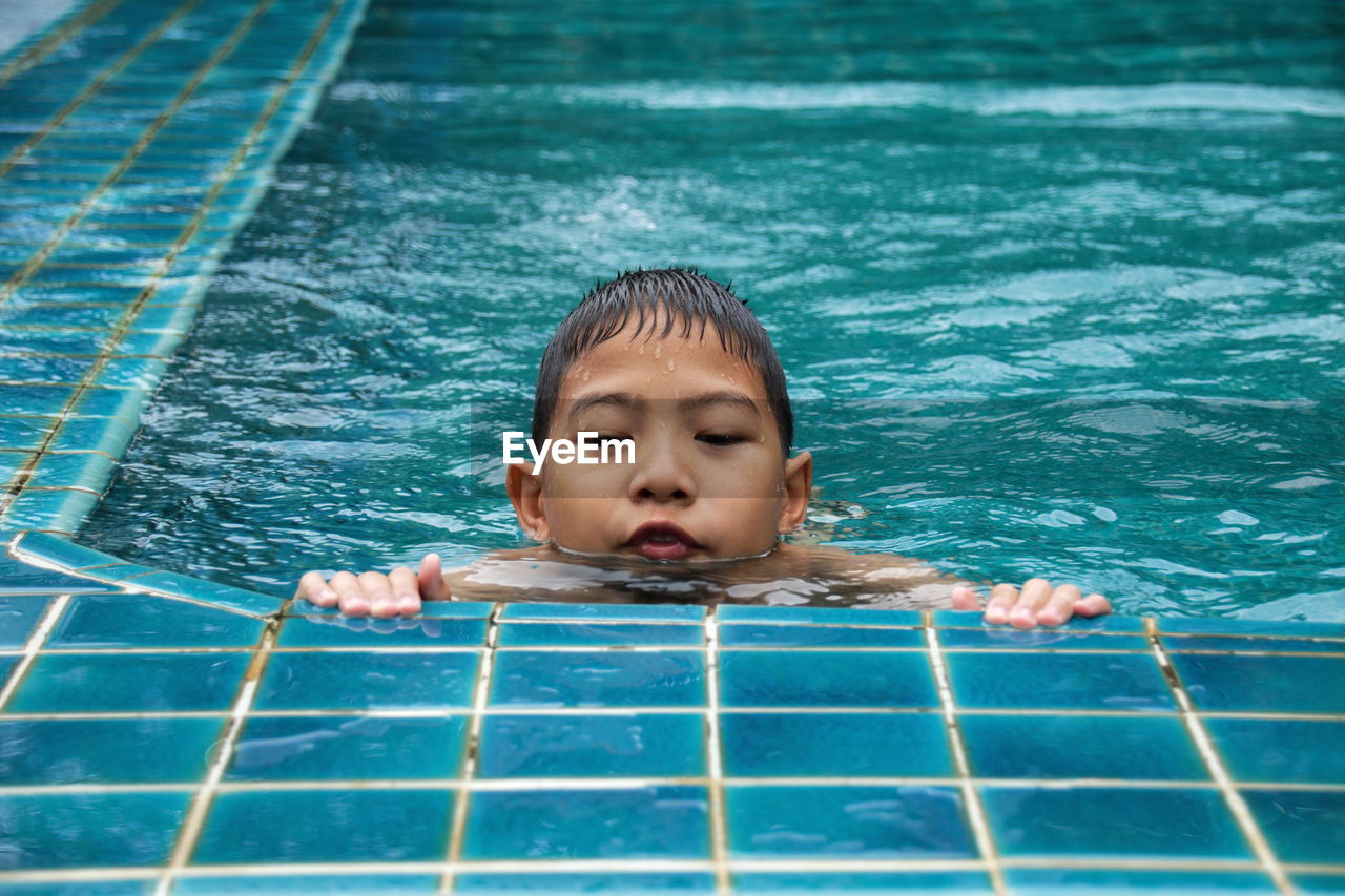 Boy swimming in pool