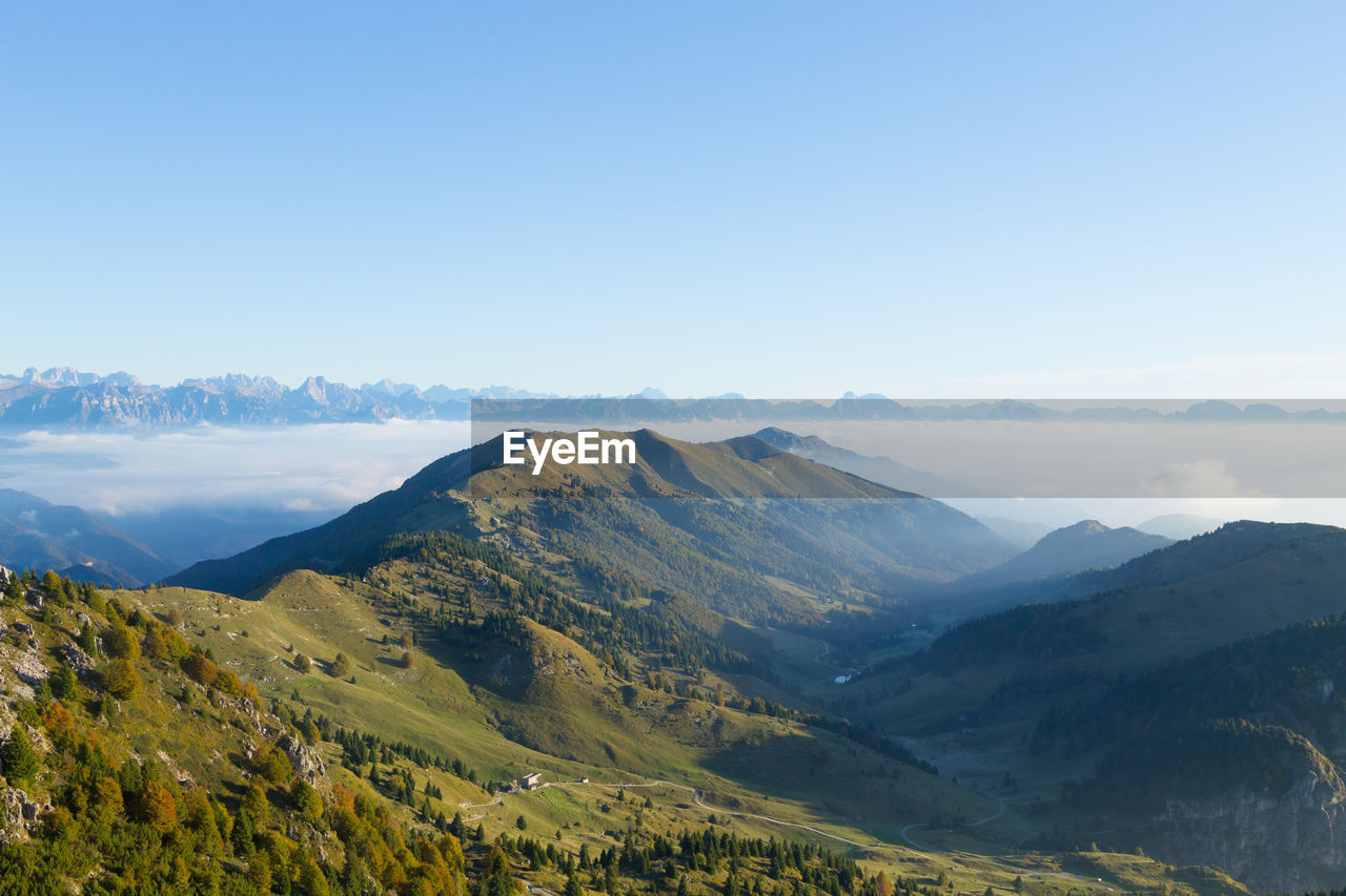 SCENIC VIEW OF MOUNTAIN RANGE AGAINST BLUE SKY