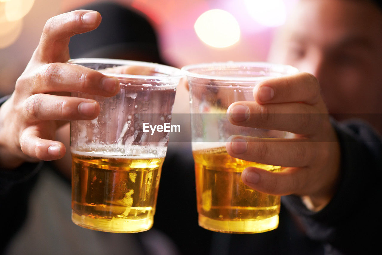 close-up of hand holding beer glass