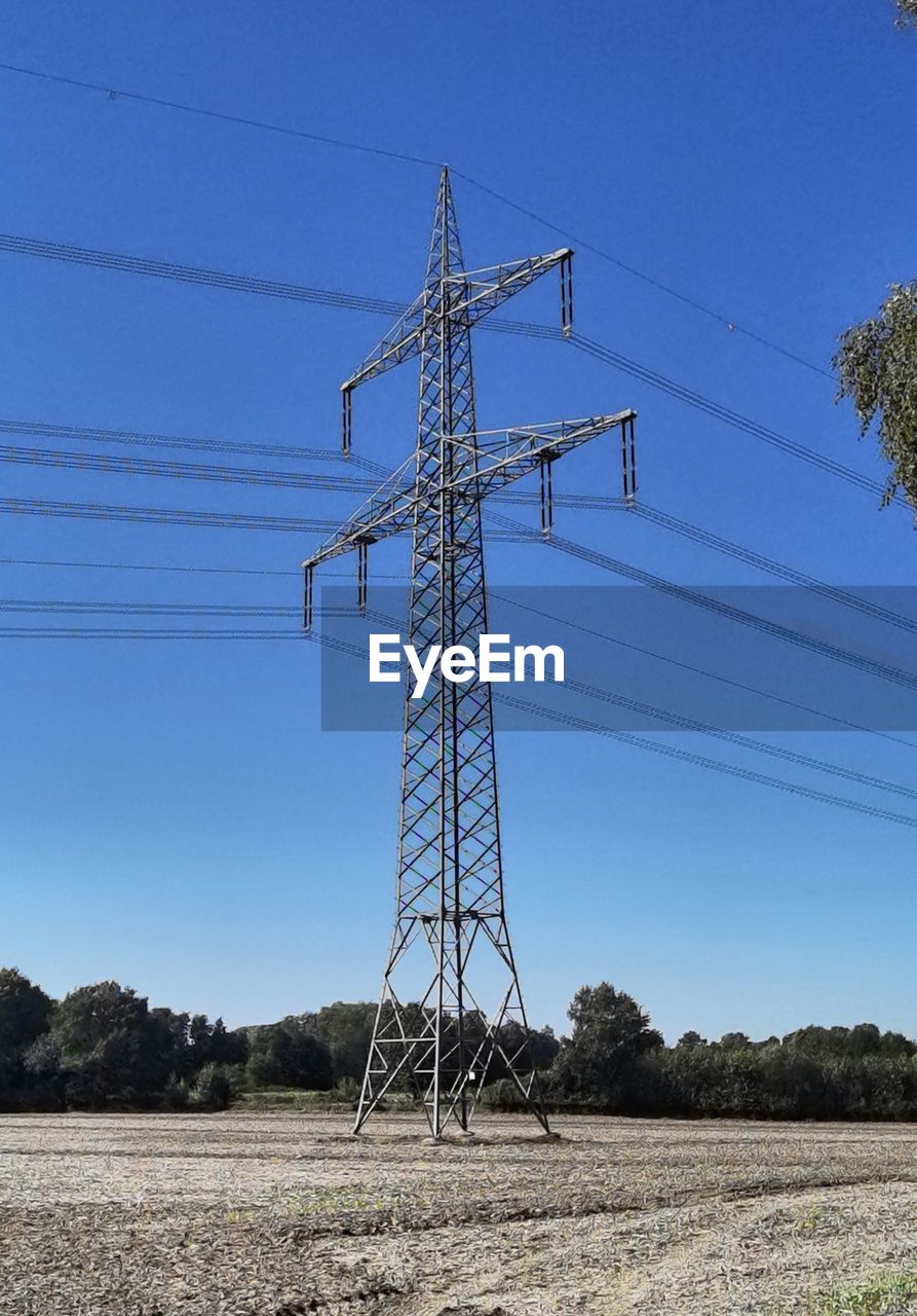 Low angle view of electricity pylon against sky