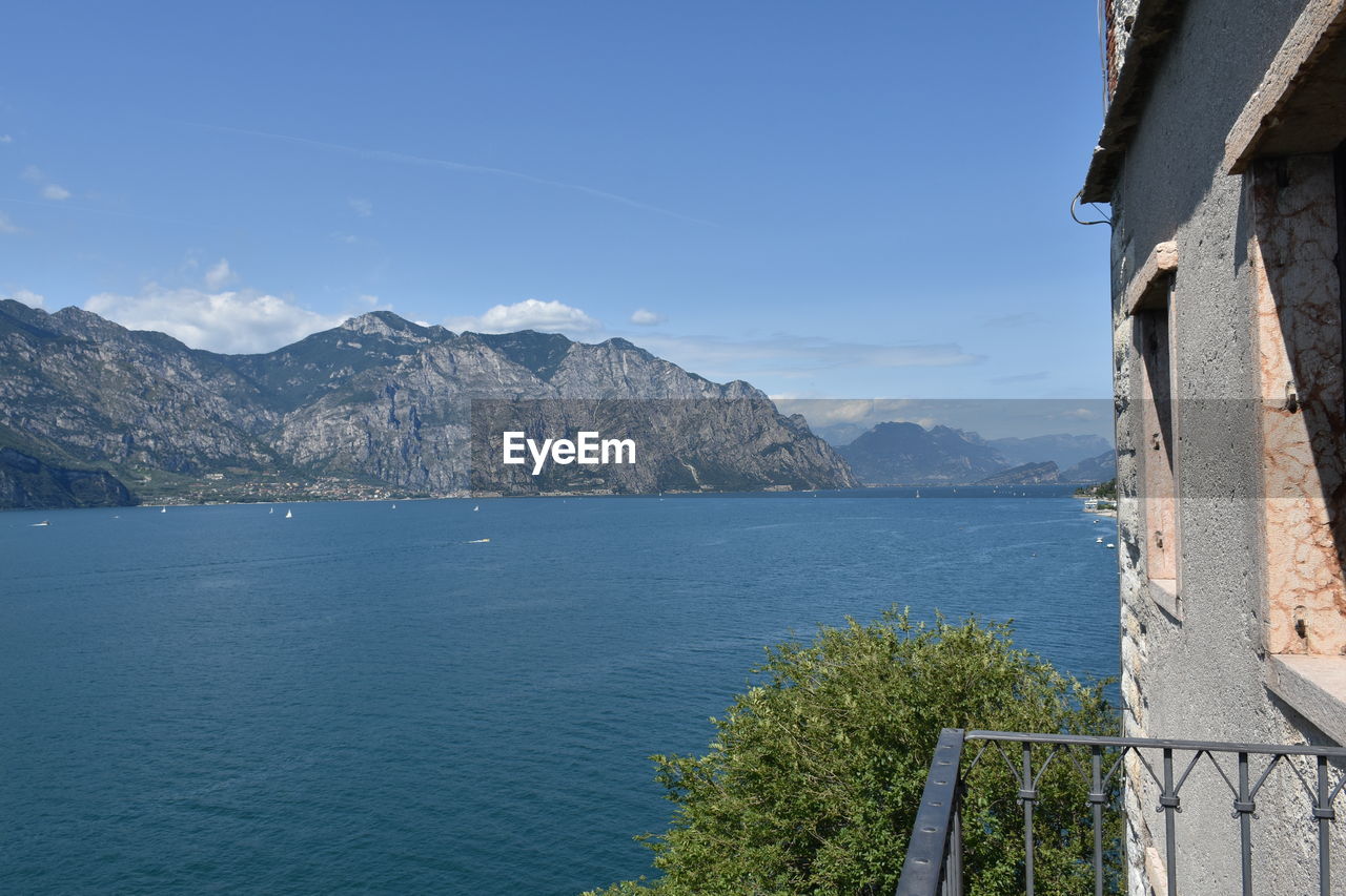 SCENIC VIEW OF SEA AND MOUNTAIN AGAINST SKY
