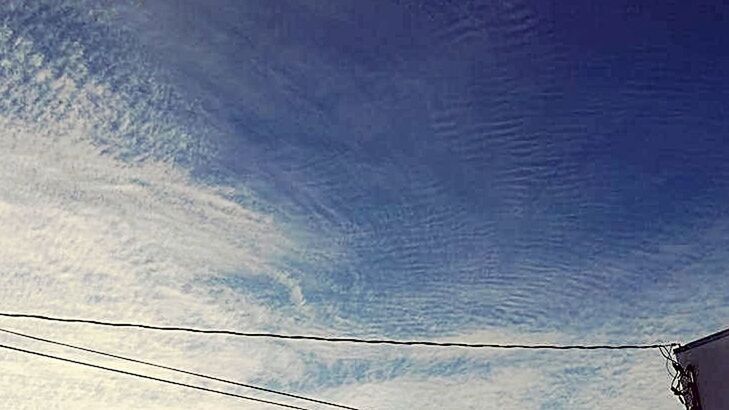 LOW ANGLE VIEW OF POWER LINES AGAINST BLUE SKY