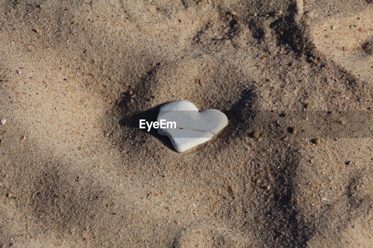 Close-up of heart shape on sand