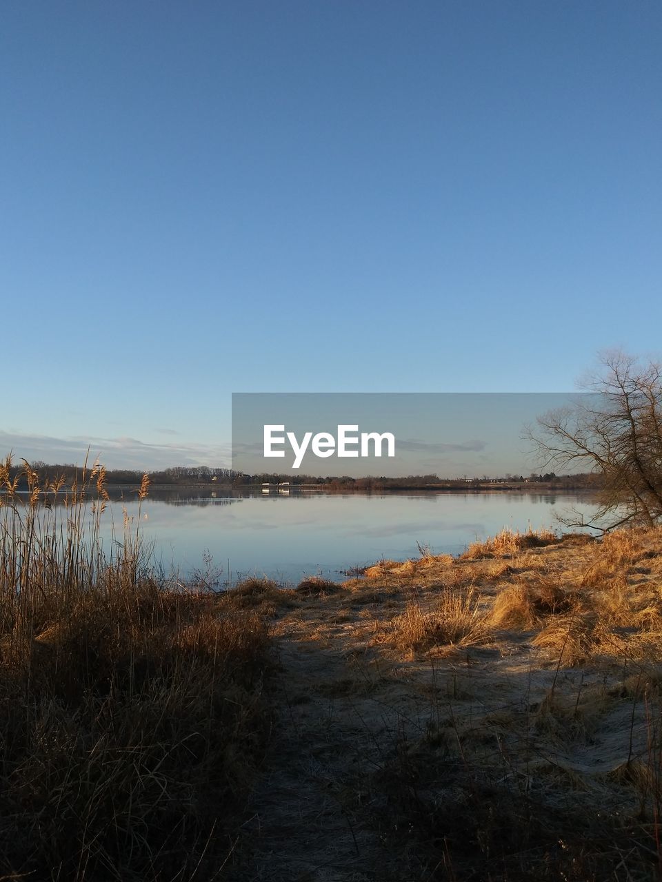 SCENIC VIEW OF LAKE AGAINST BLUE SKY