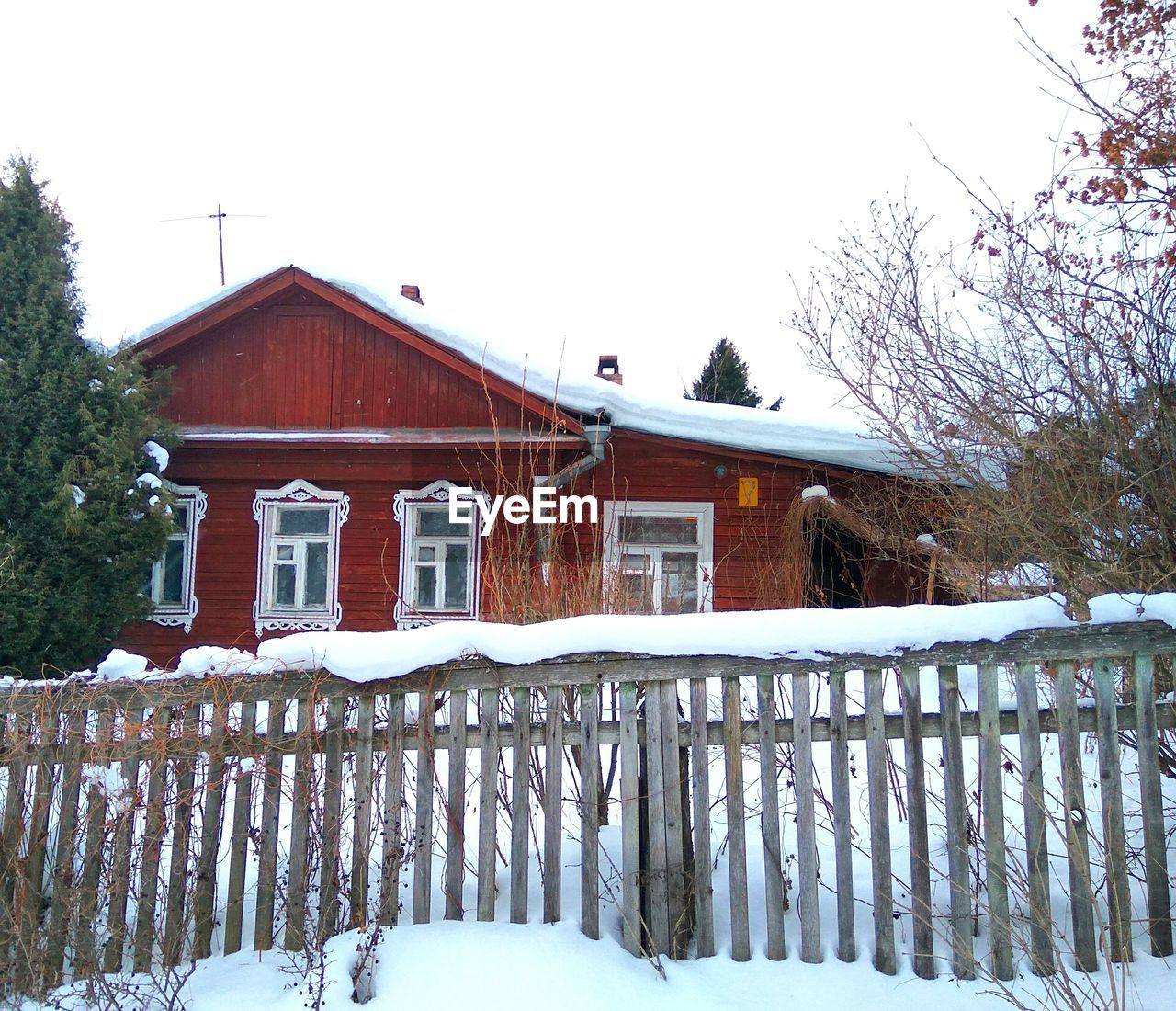 SNOW COVERED BUILT STRUCTURE AGAINST TREES