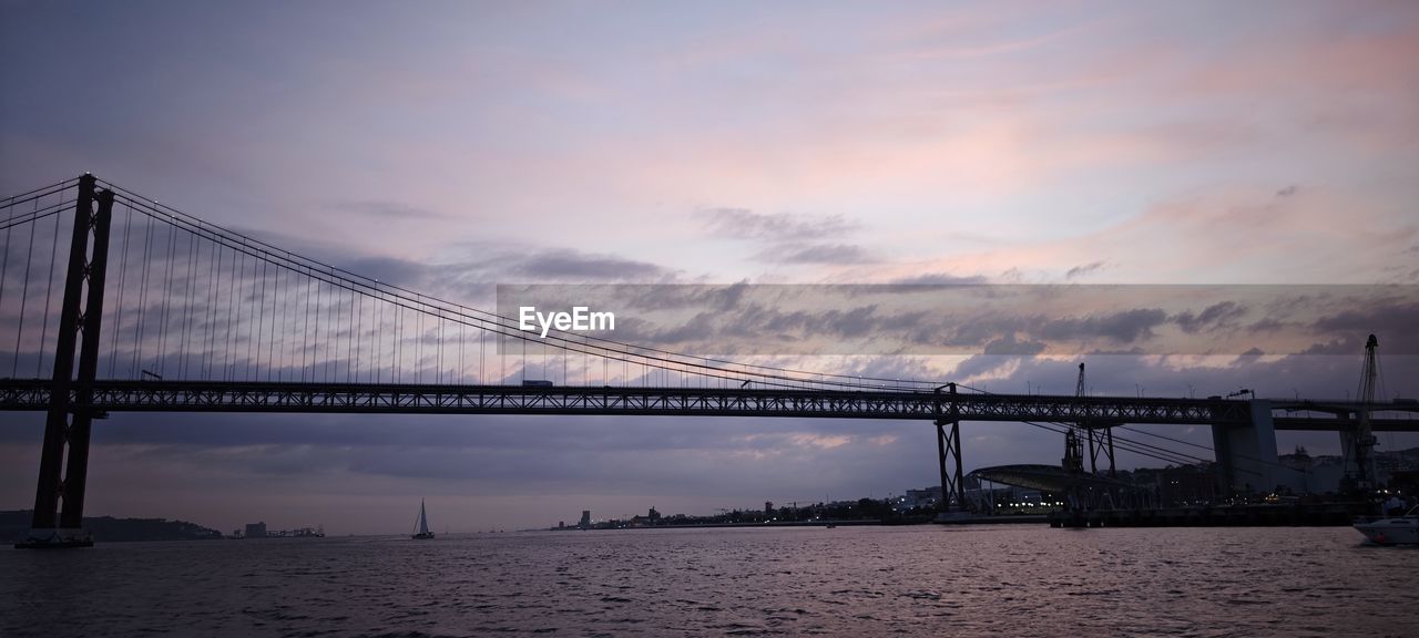 architecture, bridge, sky, built structure, water, transportation, travel destinations, cloud, nature, city, sea, dramatic sky, sunset, suspension bridge, dusk, engineering, travel, tourism, beauty in nature, fog, scenics - nature, reflection, landscape, evening, atmospheric mood, tranquility, twilight, cityscape, urban skyline, bay, building exterior, moody sky, environment, bay of water, tranquil scene, business finance and industry, horizon, outdoors, idyllic, mode of transportation, city life, beach, awe, cloudscape, industry, street, building, alloy, copy space, night, panoramic, holiday, steel, long exposure, silhouette, nautical vessel, construction industry, coastline, man made structure, land, seascape, road, water's edge, business, man made, trip, overcast, red, vacation, cable-stayed bridge