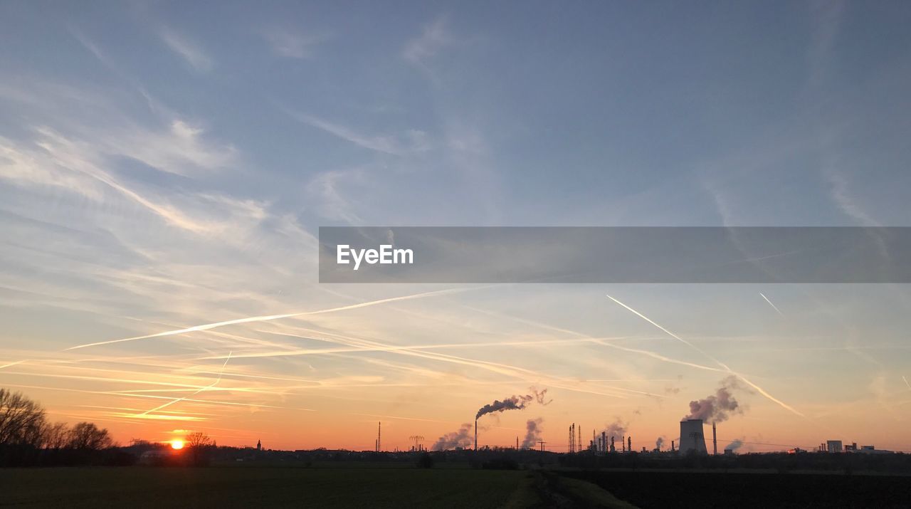 SILHOUETTE OF WIND TURBINE AGAINST SKY DURING SUNSET