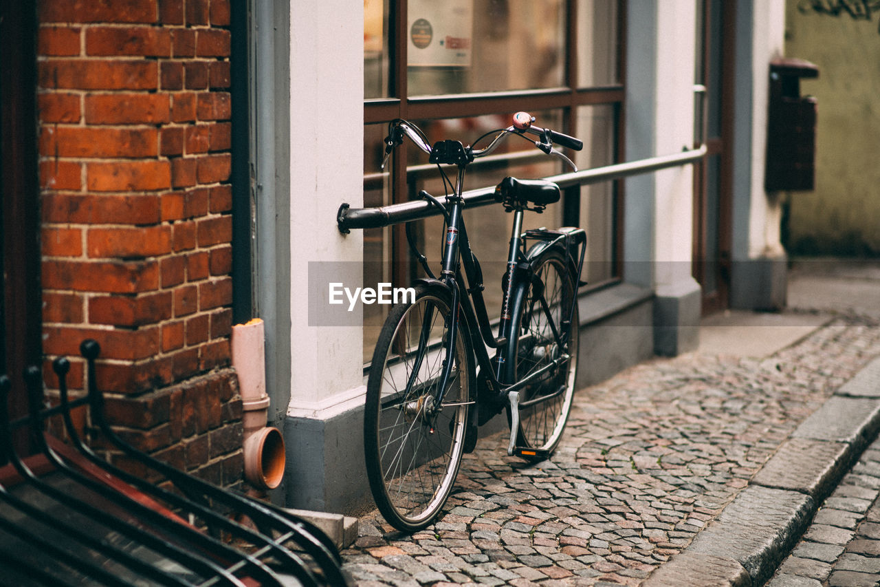 BICYCLE ON STREET BY WALL