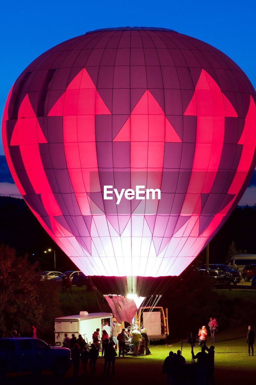 PEOPLE IN HOT AIR BALLOONS AGAINST SKY