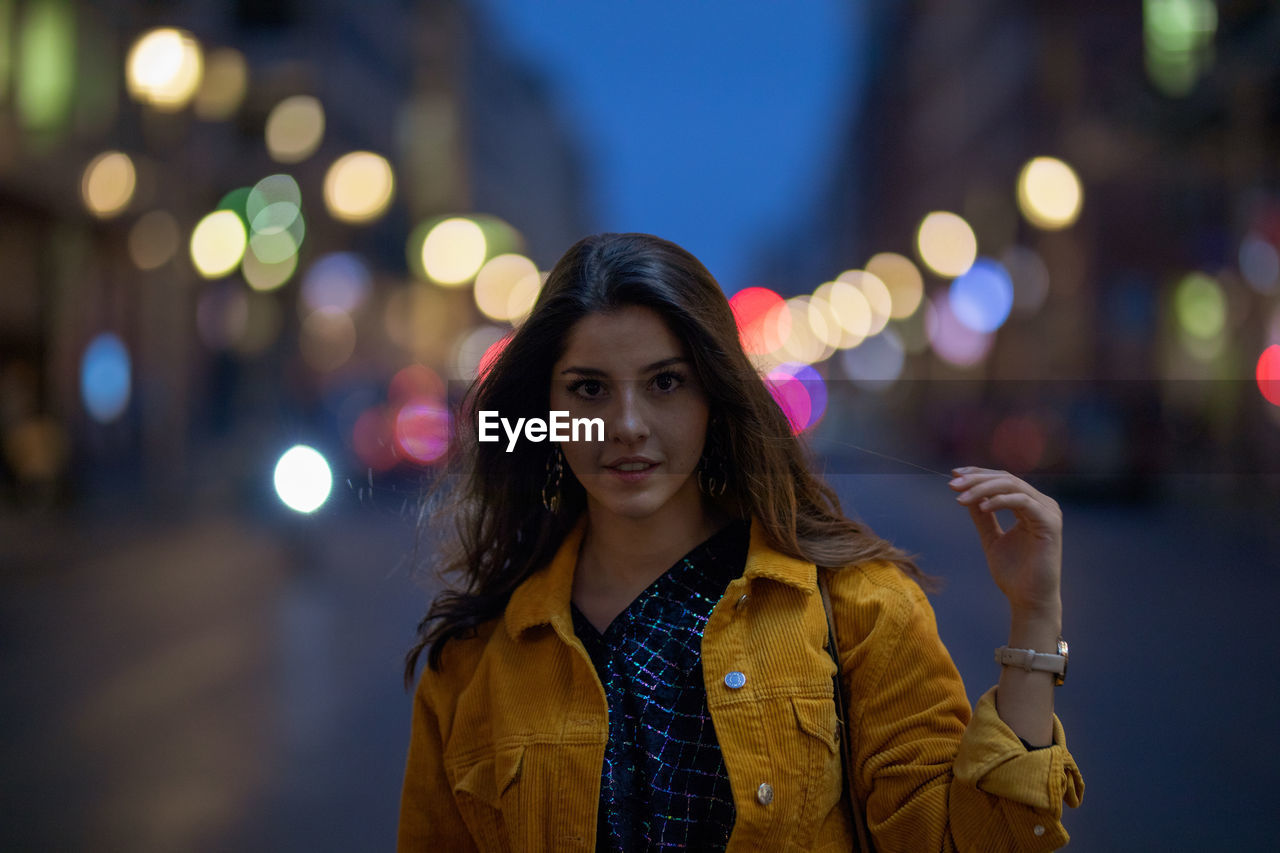 Portrait of young woman on street