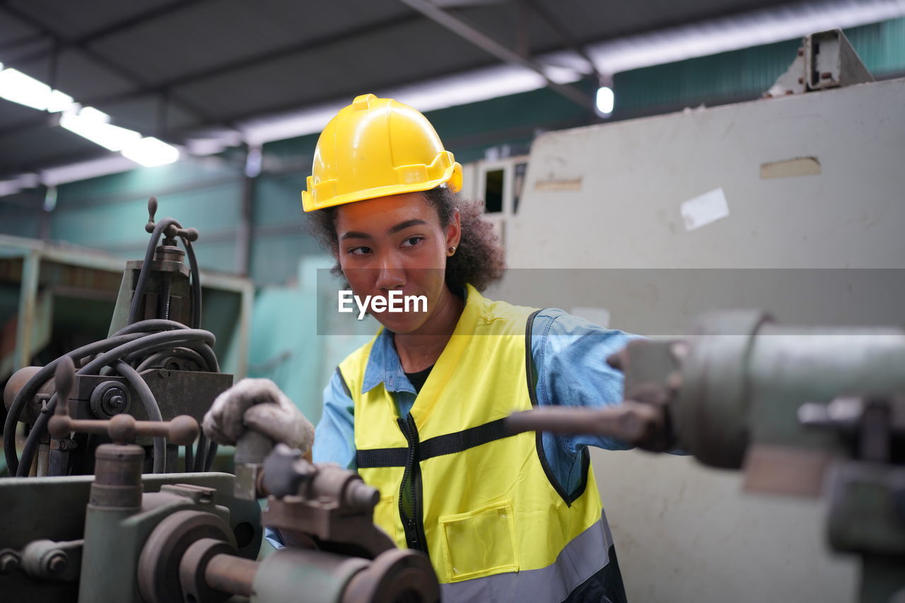 rear view of engineer working in factory