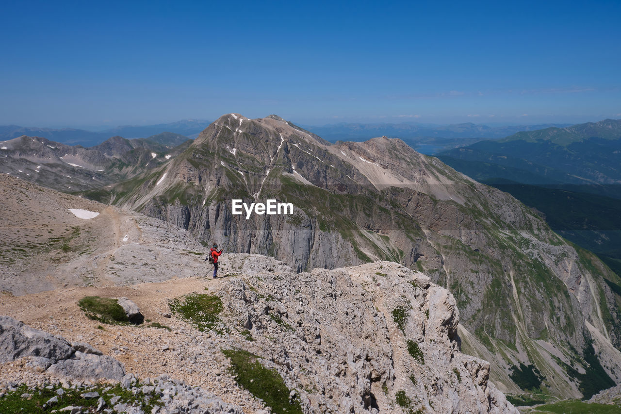 Mountaineer observing the landscape of the mountains of the laga gran sasso abruzzo