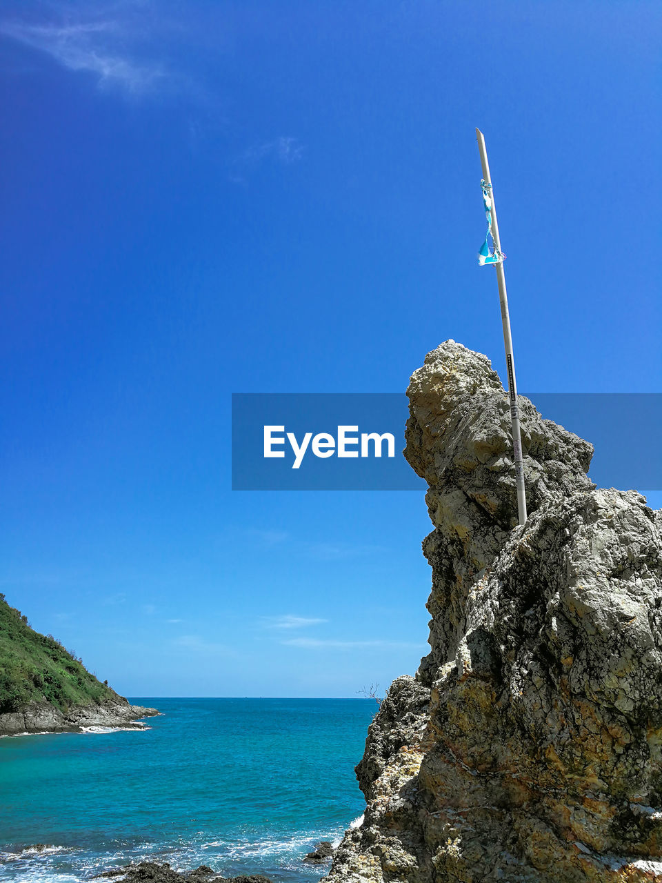ROCK FORMATION ON SEA AGAINST SKY