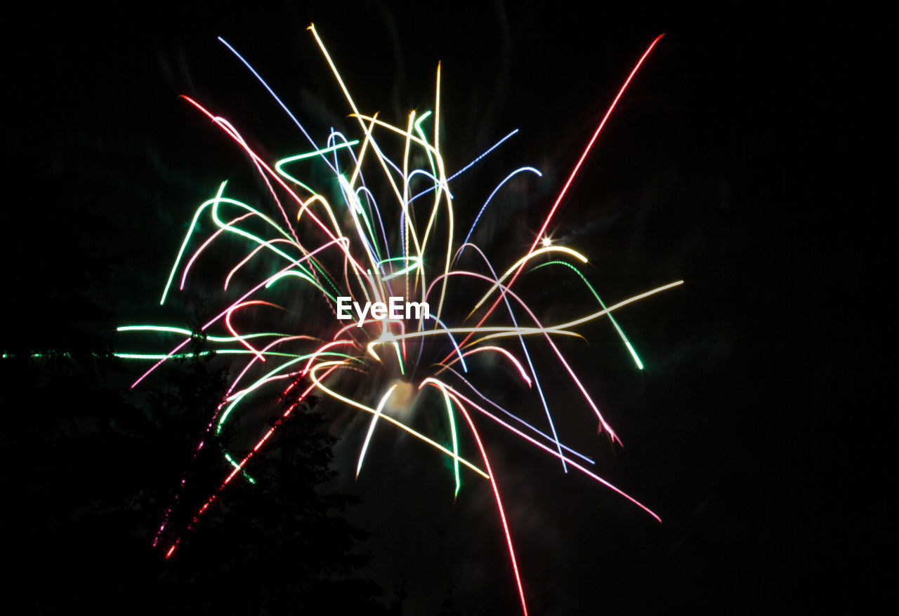 Low angle view of firework display at night