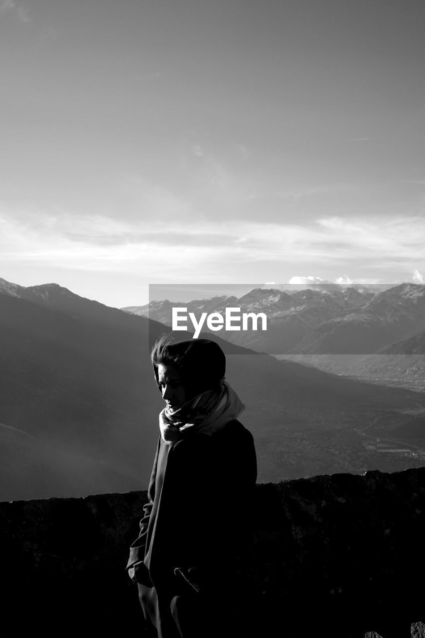 Man standing on mountain against sky