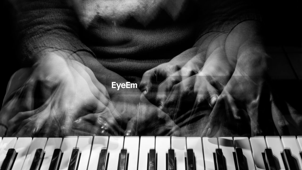 Blurred motion of man playing piano