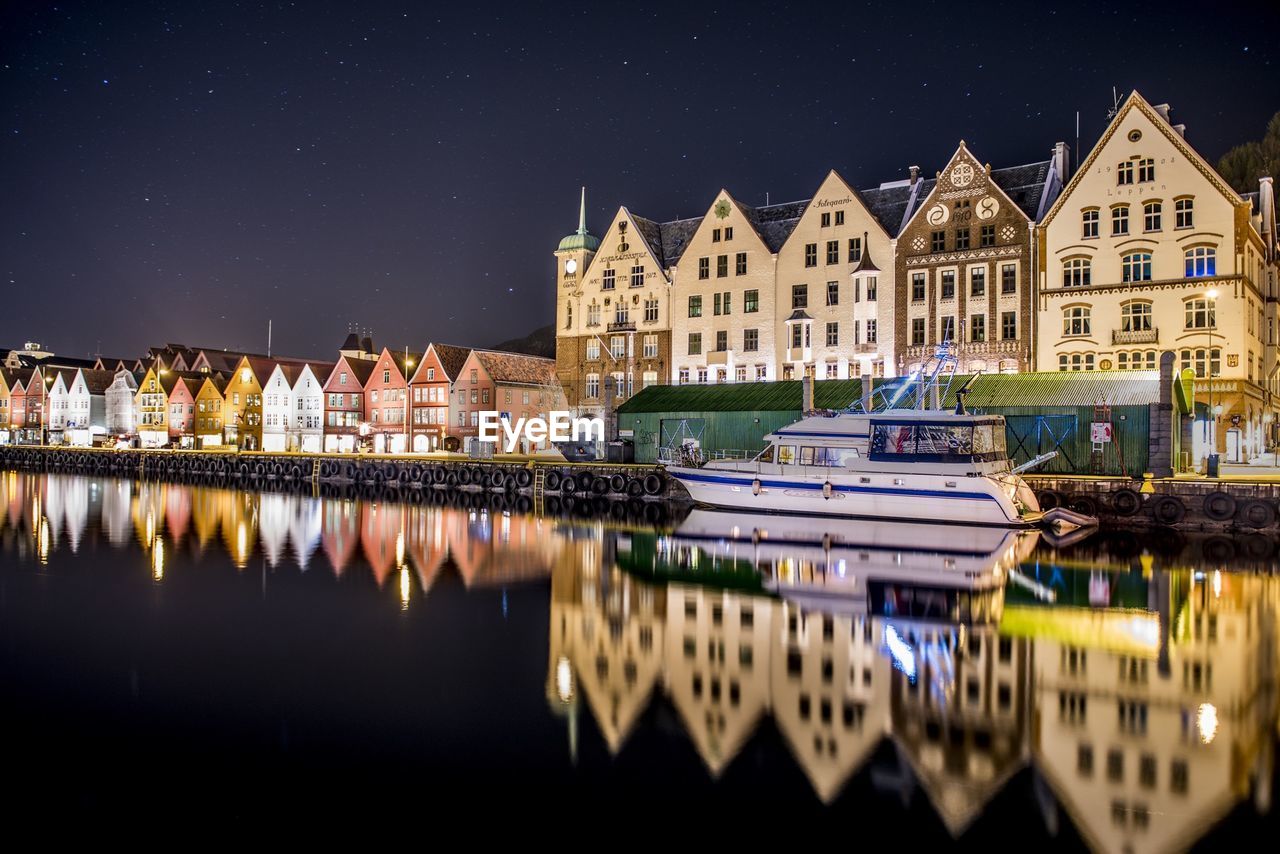 Illuminated buildings against sky at night