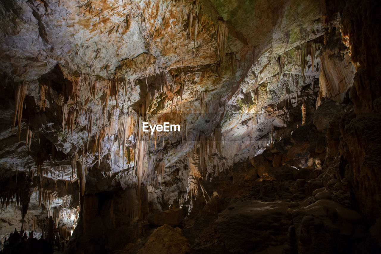 LOW ANGLE VIEW OF ROCKS IN CAVE