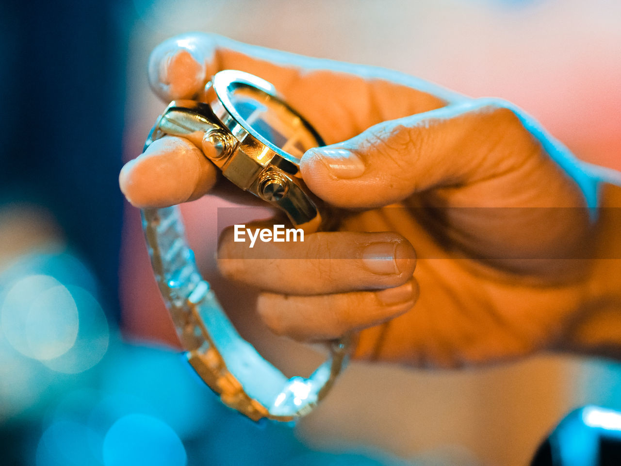 Close-up of hand holding wristwatch