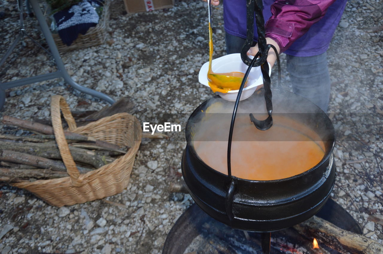 LOW SECTION OF MAN PREPARING FOOD