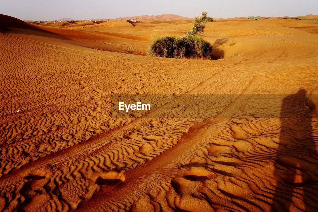 High angle view of person shadow on sand at desert