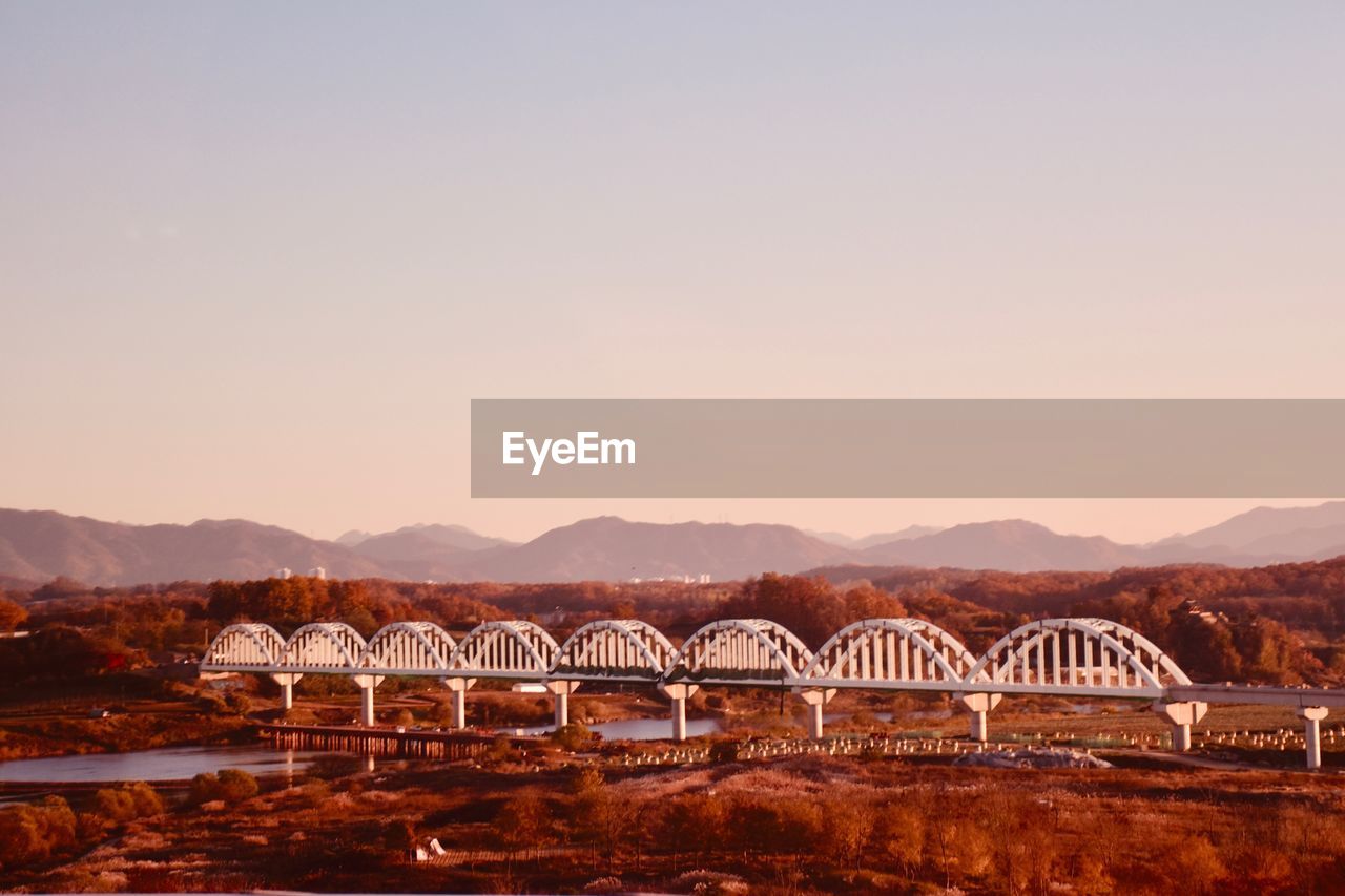 ARCH BRIDGE OVER RIVER AGAINST CLEAR SKY