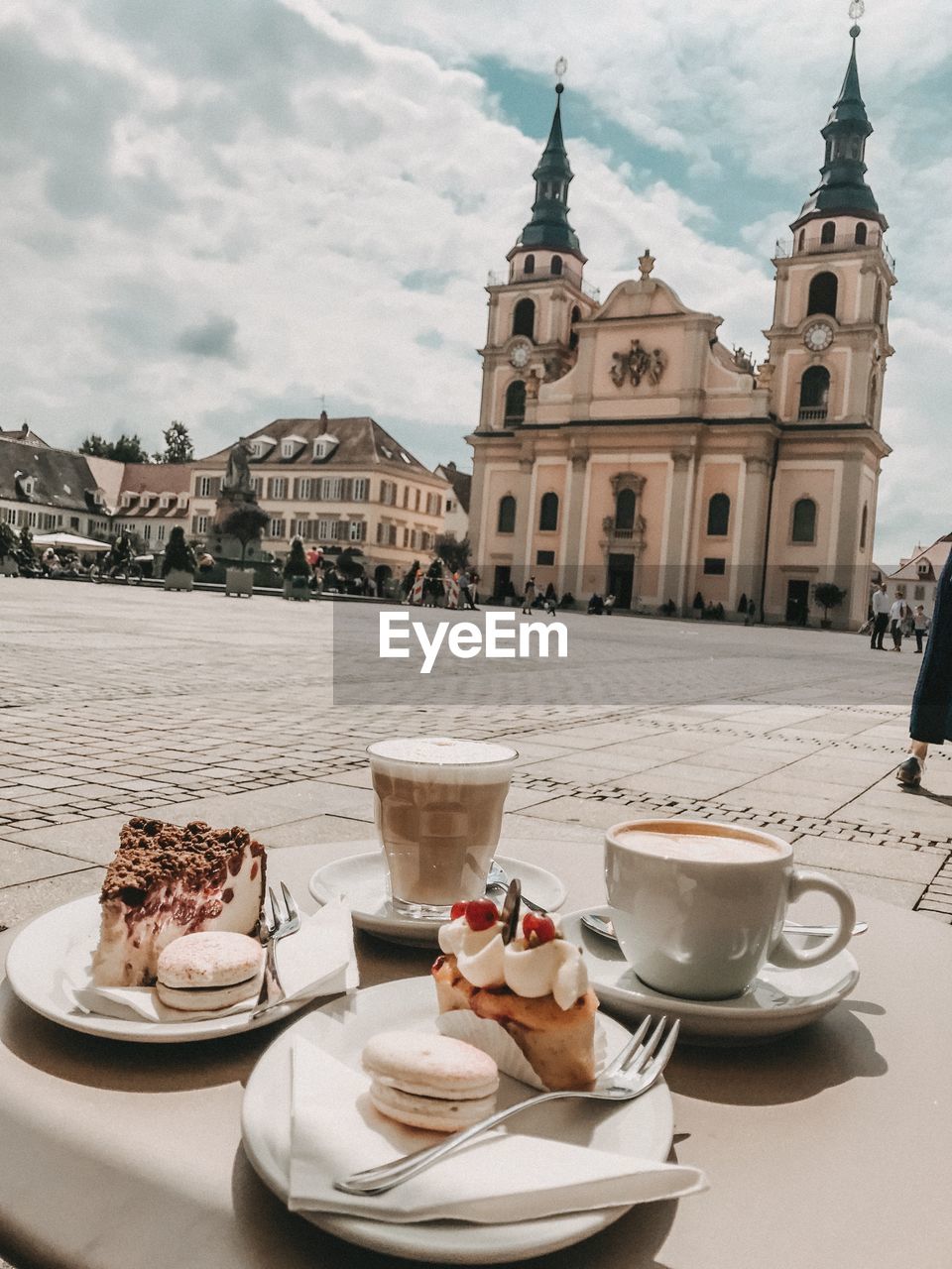 Breakfast served on table in city against sky