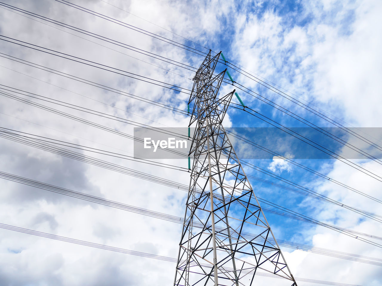 Low angle view of electricity pylon against sky