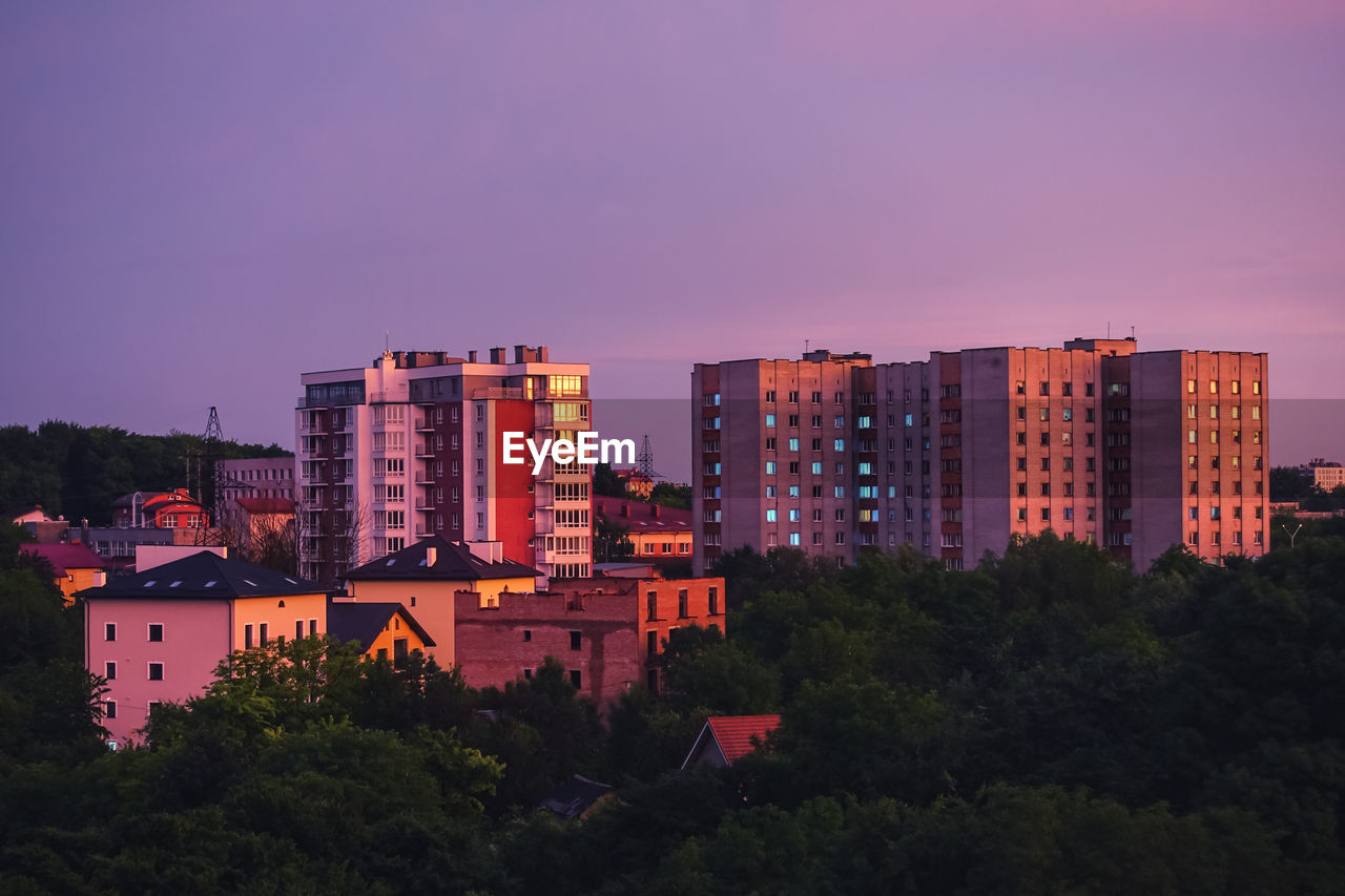 Buildings in city against sky at sunset. panoramic view.