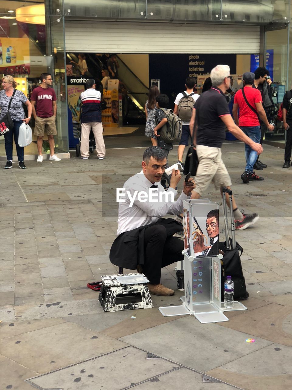 PEOPLE SITTING ON STREET